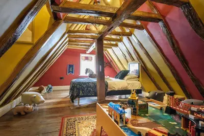 a bedroom with a bed in a attic at The Famous Harry Potter House, Hot Tub, Cinema Room, Sky TV in Saffron Walden