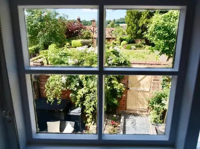 a view through a window of a garden at The Famous Harry Potter House, Hot Tub, Cinema Room, Sky TV in Saffron Walden