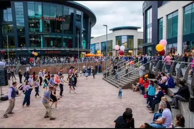 a crowd of people walking around in a plaza with balloons at New Horizon - A beautiful boat very conveniently located in Chelmsford City in Chelmsford
