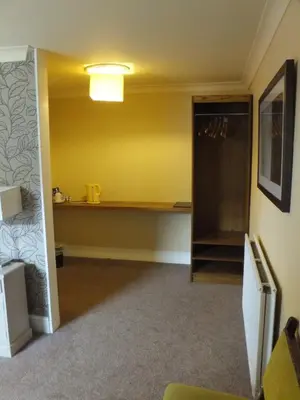 an empty room with a refrigerator and a shelf at The Red Lion, Stretham in Ely