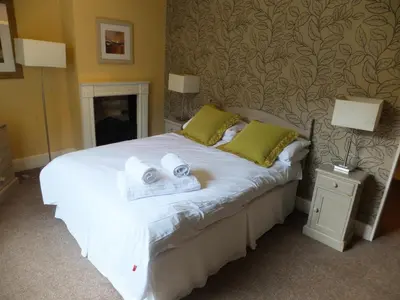 a bedroom with a bed with two towels on it at The Red Lion, Stretham in Ely