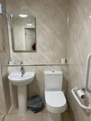 a bathroom with a white toilet and a sink at The Red Lion, Stretham in Ely