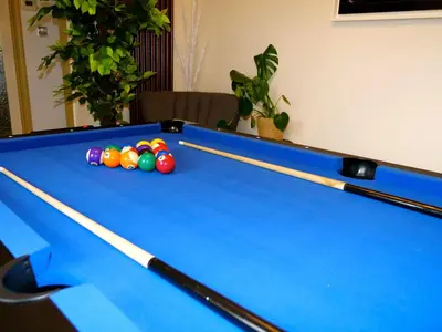 a pool table with balls on top of it at Deluxe 2 3 Bed HotTub SkyTV in Saffron Walden