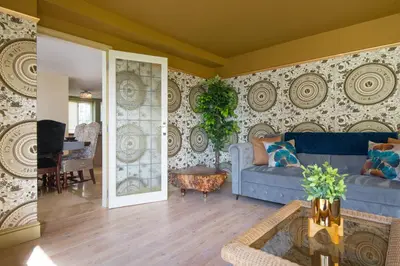 a living room with a blue couch and a table at Deluxe 2 3 Bed HotTub SkyTV in Saffron Walden