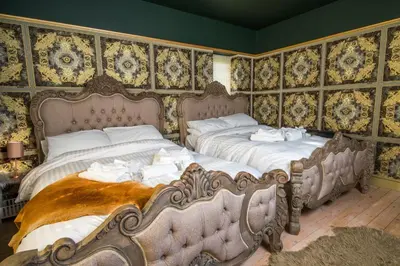 two beds sitting next to each other in a bedroom at Deluxe 2 3 Bed HotTub SkyTV in Saffron Walden