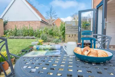 a table with a bowl of bread on top of it at 111 Front Street, Orford in Woodbridge