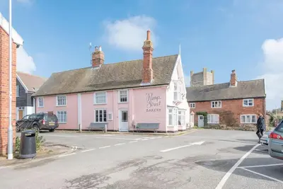 a pink building on the side of a street at 111 Front Street, Orford in Woodbridge