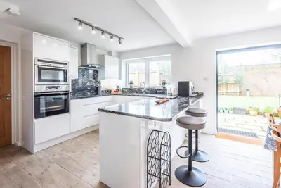 a kitchen with white cabinets and a counter top at 111 Front Street, Orford in Woodbridge