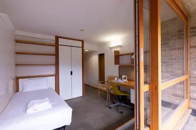 a bedroom with a bed and a desk in a room at Harvey Court Gonville and Caius College in Cambridge