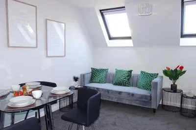 a living room with a couch and a table at Tulip Place in Chelmsford