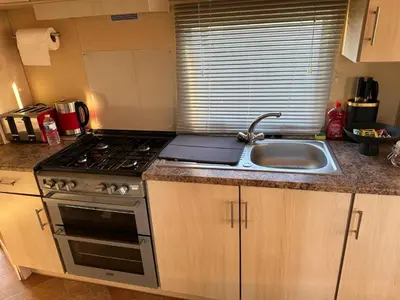 a kitchen with a stove and a sink at CaSa VistA - Holiday Home On The Beach in Clacton-on-Sea