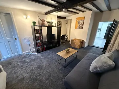 a living room with a couch and a tv at Apartment - Sleeps 2 - Parking - WiFi in Colchester