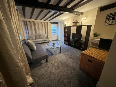 a living room with a couch and a tv at Apartment - Sleeps 2 - Parking - WiFi in Colchester