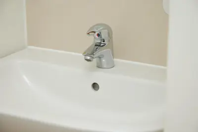 a bathroom sink with a faucet on top of it at White Hart Hotel by Greene King Inns in Braintree
