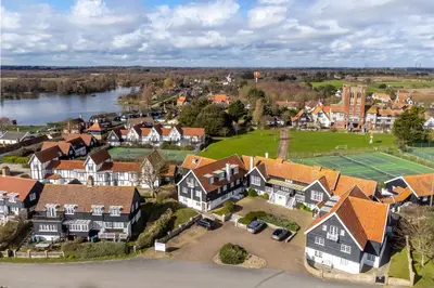 an aerial view of a house with a tennis court at 4 Truman Lodge in Thorpeness