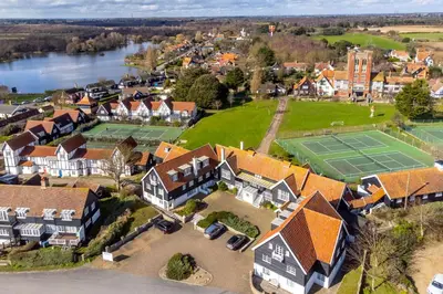 an aerial view of a house with a tennis court at 4 Truman Lodge in Thorpeness