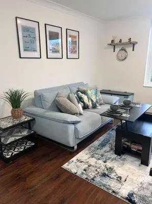 a living room with a couch and a table at Priory park view in Southend-on-Sea