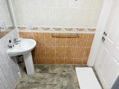 a small bathroom with a sink and a shower at 4 Sisters Inn in Theydon Bois