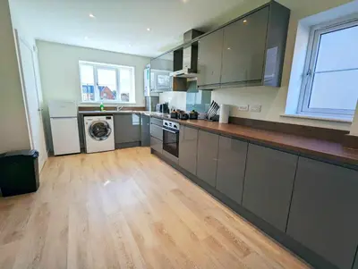 a large kitchen with a washer and dryer in it at 3-Bed, Sleeps 5, 3 Bath, Parking, WiFi in Watton