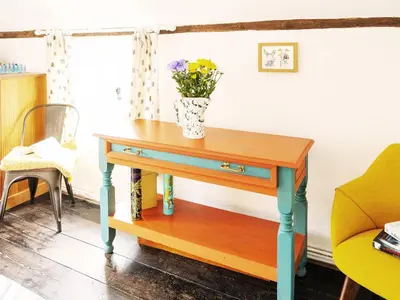 a table with a vase of flowers on top of it at Prospect Place by The Suffolk Cottage Collection in Westleton