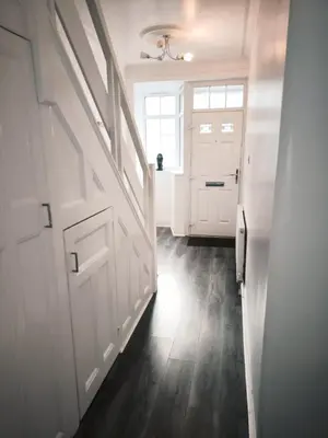 a hallway with a white door and a window at Spacious 3 Bedroom Home, Sleeps 7, Long-Stay & Contractor Friendly, Family & Professional Ready, Clark Property Estates in Southend-on-Sea