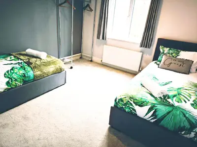 a bedroom with two beds and a window at Spacious 3 Bedroom Home, Sleeps 7, Long-Stay & Contractor Friendly, Family & Professional Ready, Clark Property Estates in Southend-on-Sea