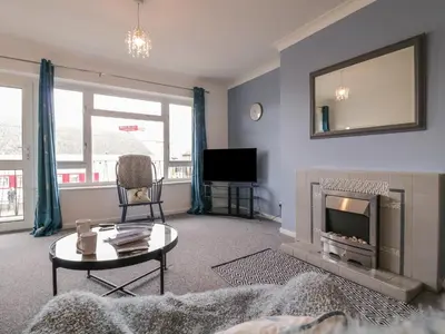 a living room with a fireplace and a tv at The Upper Circle in Clacton-on-Sea