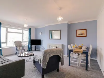 a living room with a couch and a table at The Upper Circle in Clacton-on-Sea