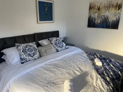 a bed with pillows on it in a bedroom at Charming 3 bedroom flint cottage in Lakenheath