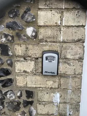 a brick wall with an electronic device on it at Charming 3 bedroom flint cottage in Lakenheath