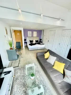 a large living room with a couch and a bed at Cambridge City Centre Studio First Floor Sleeps 3 in Cambridge