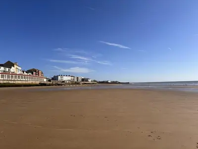an empty beach with buildings in the background at High view house, 3 bed flat, Number 41A in Walton-on-the-Naze