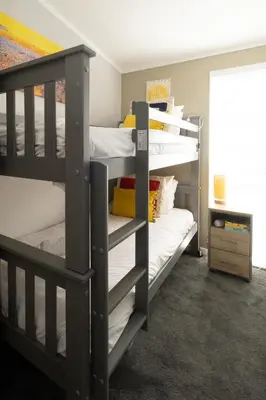 two bunk beds in a small room with a room at Pebbles - Church Farm - Aldeburgh Coastal Cottages in Aldeburgh