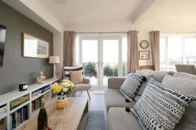 a living room with a couch and a table at Pebbles - Church Farm - Aldeburgh Coastal Cottages in Aldeburgh