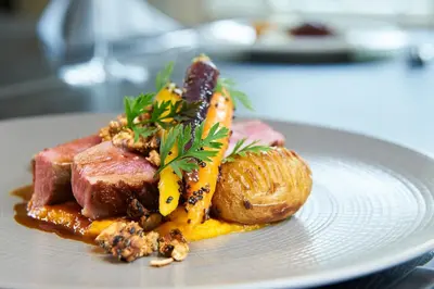 a plate of food with meat and vegetables on it at The Oaksmere in Eye