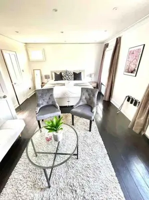 a living room with a bed and a table and chairs at Historical Police Station Building l Central Cambridge I Park View in Cambridge
