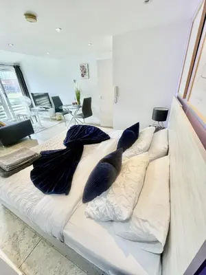 a large bed in a room with pillows on it at Studio - Sleeps 3 - Parking - Wifi in Cambridge