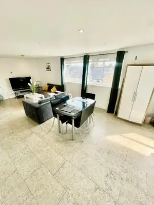 a living room with a couch and a table at City Centre Cozy Studio flat Second Floor in Cambridge
