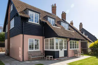 a house with a bench in front of it at 9 The Haven in Thorpeness