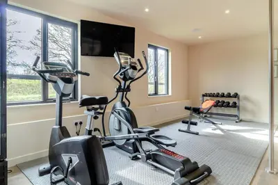 a gym with two exercise bikes and a flat screen tv at 2 Bed in Heveningham oc-w29029 in Heveningham