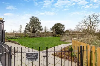 a gate with a sign in front of a garden at 2 Bed in Heveningham oc-w29034 in Heveningham