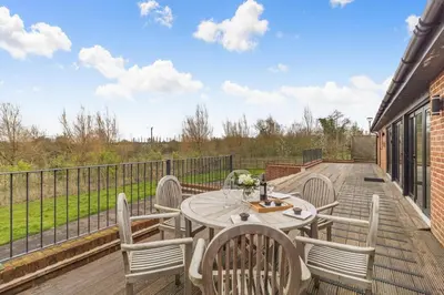 a patio with a table and chairs on a deck at 4 Bed in Heveningham oc-w29036 in Heveningham
