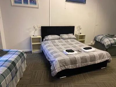 a bedroom with two beds with towels on them at The Stables in Takeley