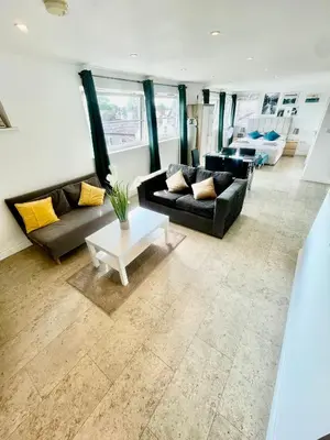 a living room with two couches and a table at Studio - Sleeps 2 - Parking - Wifi in Cambridge