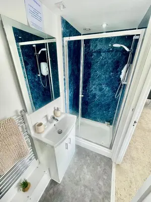 a bathroom with a white sink and a shower at Studio - Sleeps 2 - Parking - Wifi in Cambridge