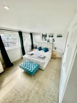 a bedroom with a bed and a blue stool at Studio - Sleeps 2 - Parking - Wifi in Cambridge