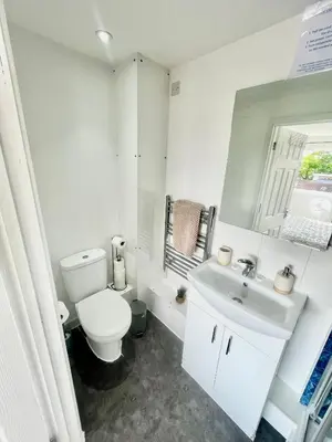 a white bathroom with a toilet and a sink at Studio - Sleeps 2 - Parking - Wifi in Cambridge