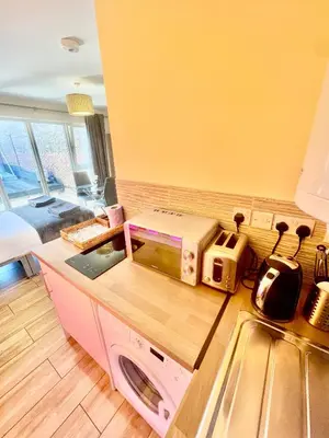 a kitchen with a pink washing machine on a counter at cambridge city centre immaculate Studio sleeps 2 - central location paradise street in Cambridge