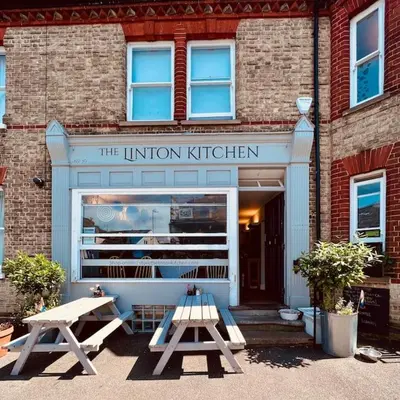 a library with two picnic tables in front of a building at The Hideout in Linton