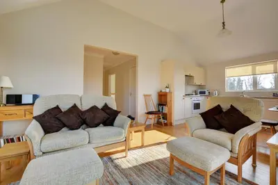 a living room with two couches and a kitchen at 2 Bed in Attleborough oc-1277 in Old Buckenham